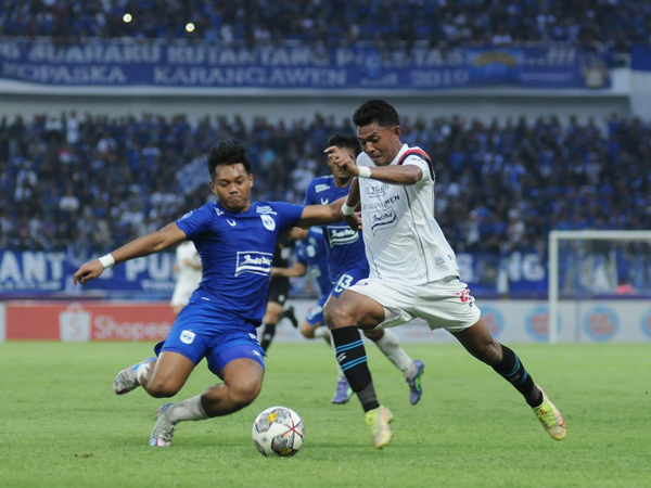 Penyerang Arema FC, Dedik Setiawan berupaya melewati pemain PSIS Semarang