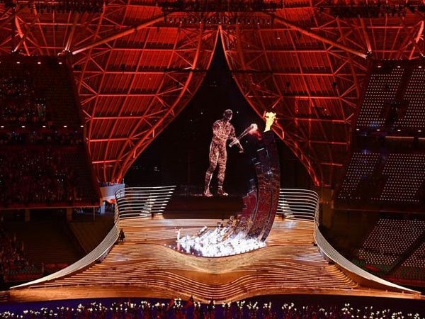 Detik-detik Wang Shun dan sosok pembawa obor digital menyalakan kaldron api pada upacara pembukaan Asian Games Hangzhou. (Foto: Xinhua)