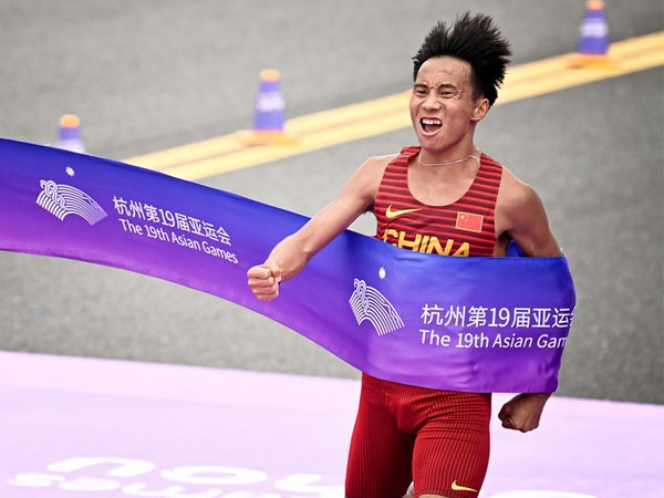 He Jie dari China melintasi garis finis saat final maraton putra di Asian Games hangzhou. (Xinhua/Jiang Han)