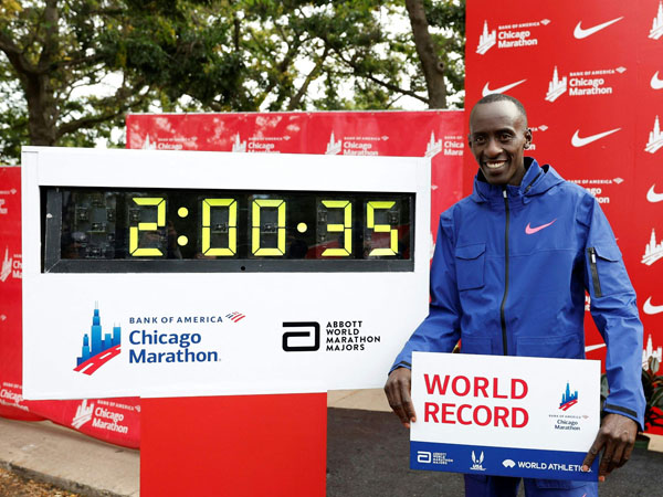 Kelvin Kiptum berpose dengan papan waktu yang menunjukkan pemecahan rekor dunia oleh dirinya di ajang Maraton Chicago. (Foto: X.com)