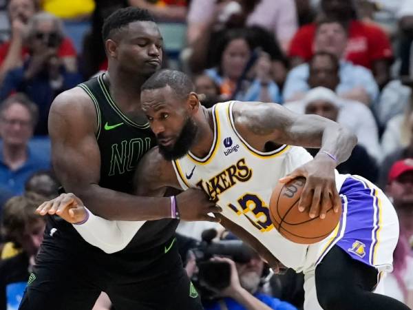 LeBron James (kanan) membukukan triple double saat Los Angeles Lakers menang 124-108 atas New Orleans Pelicans pada hari Minggu (14/4).