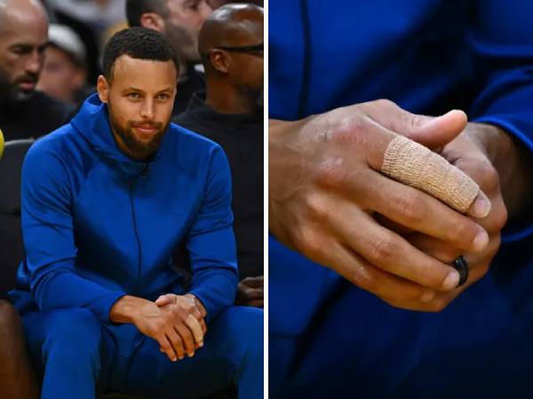 Steph Curry terlihat menonton pertandingan melawan Lakers dengan jari telunjuk kanan diperban. (Foto: AP)