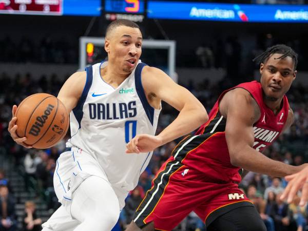 Dante Exum (kiri) mencetak 27 poin saat Dallas Mavericks mengalahkan tim tamu Miami Heat dengan skor 118-113 pada hari Kamis (13/2) malam. (Foto: AP)