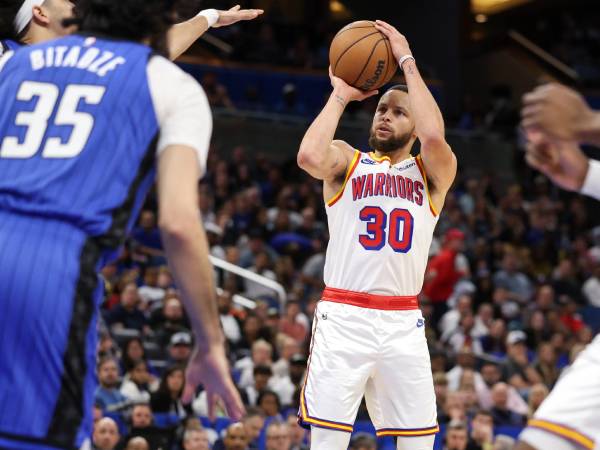 Steph Curry (kanan) mencetak 56 poin saat Golden State Warriors mengalahkan tuan rumah Orlando Magic 121-115 pada Kamis (27/2) malam. (Foto: AP)