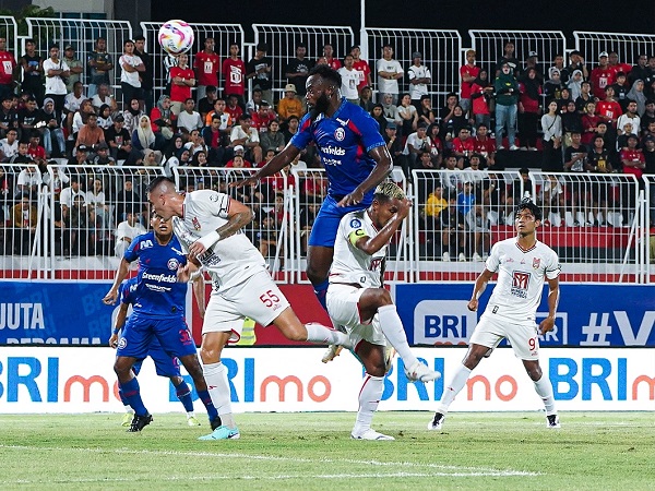 Pemain Arema FC melakukan duel udara dengan pemain Malut United FC