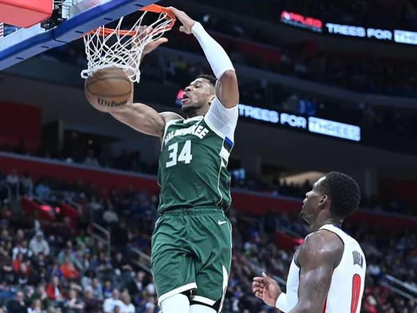 Giannis Antetokounmpo (kiri) membukukan triple-double saat Milwaukee Bucks meraih kemenangan 125-119 atas tuan rumah Detroit Pistons pada Jumat (11/4) malam. (Foto: AP)