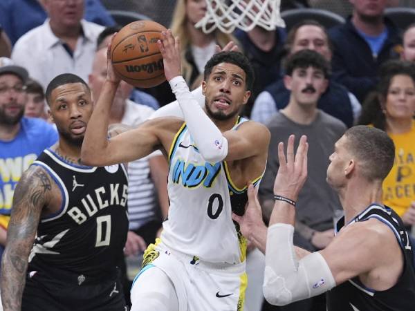 Tyrese Haliburton (tengah) mencetak 21 poin saat Indiana Pacers mengalahkan Milwaukee Bucks 123-115 pada hari Selasa (22/4) di Indianapolis. (Foto: AP)