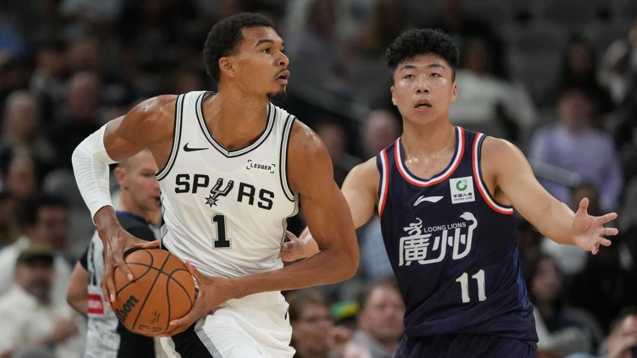 Victor Wembanyama (kiri) nyaris mencatatkan triple-double saat San Antonio Spurs menang telak 119-88 atas Guangzhou Loong-Lions pada Senin (6/10) malam. (Foto: AP)