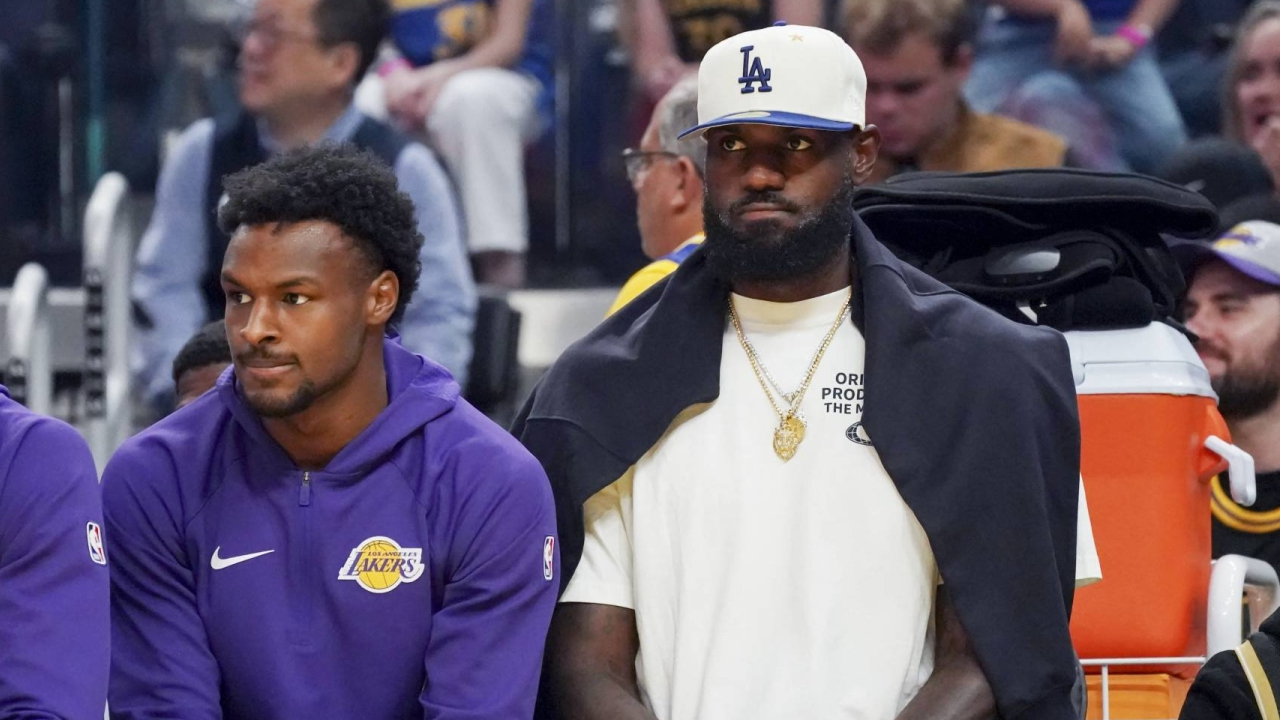LeBron James (kanan) duduk di bangku cadangan saat Lakers memainkan pertandingan pramusim. (Foto: AP)