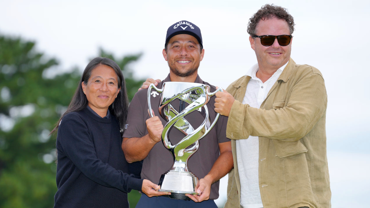 Xander Schauffele berpose dengan trofi Baycurrent Classic, diapit kedua orangtuanya. (Foto: Golf Digest)
