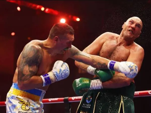 Oleksandr Usyk (kiri) sukses mengalahkan Tyson Fury melalui kemenangan angka tipis di Riyadh, Araba Saudi, pada Minggu (19/5) dini hari. (Foto: AP)
