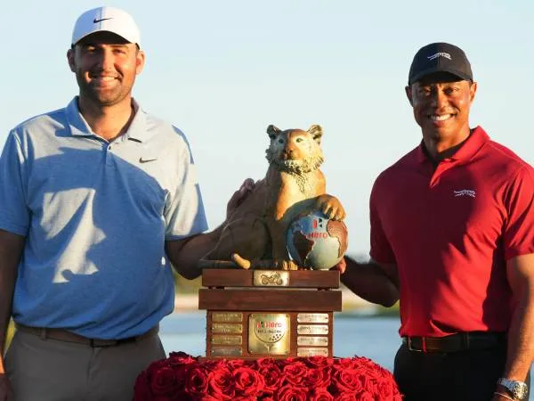 Scottie Scheffler (kiri) berpose dengan trofi Hero World Challenge bersama Toger Woods. (Foto: Golf Digest)